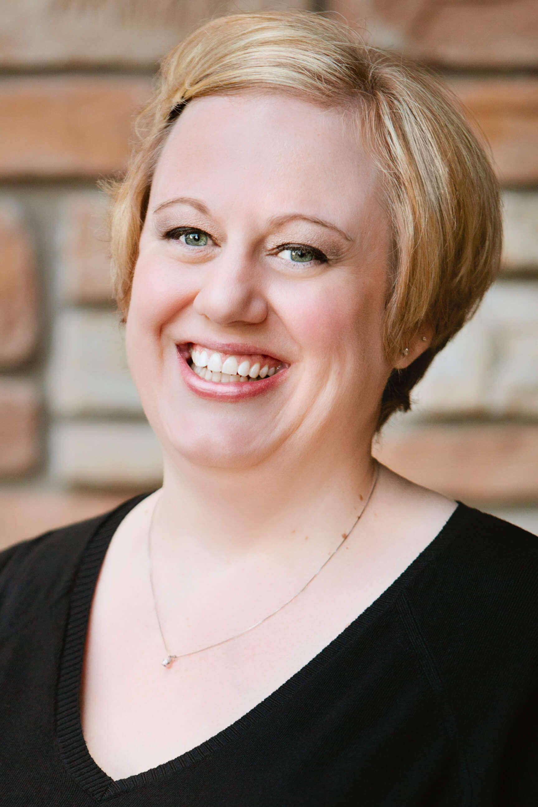 A woman smiles for the camera during her Missoula headshots