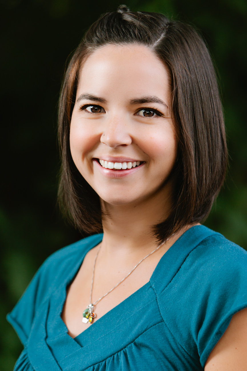 A woman employee smiles for her headshots in Missoula Montana