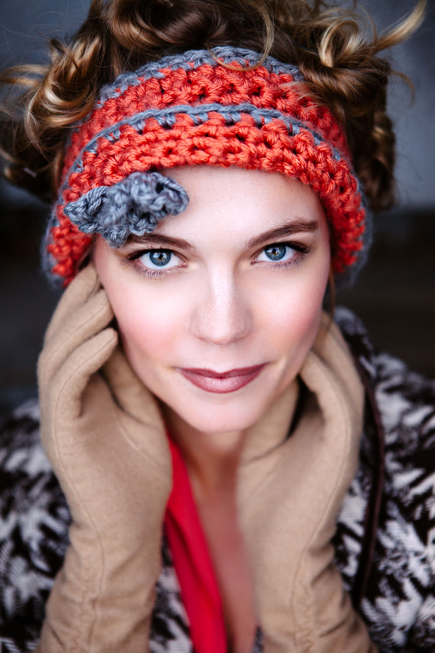 A female model wearing a crochet headband poses for her headshots in Missoula Montana
