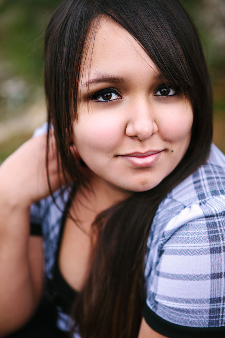 A young woman smiles for her headshots in St. Ignatius Montana