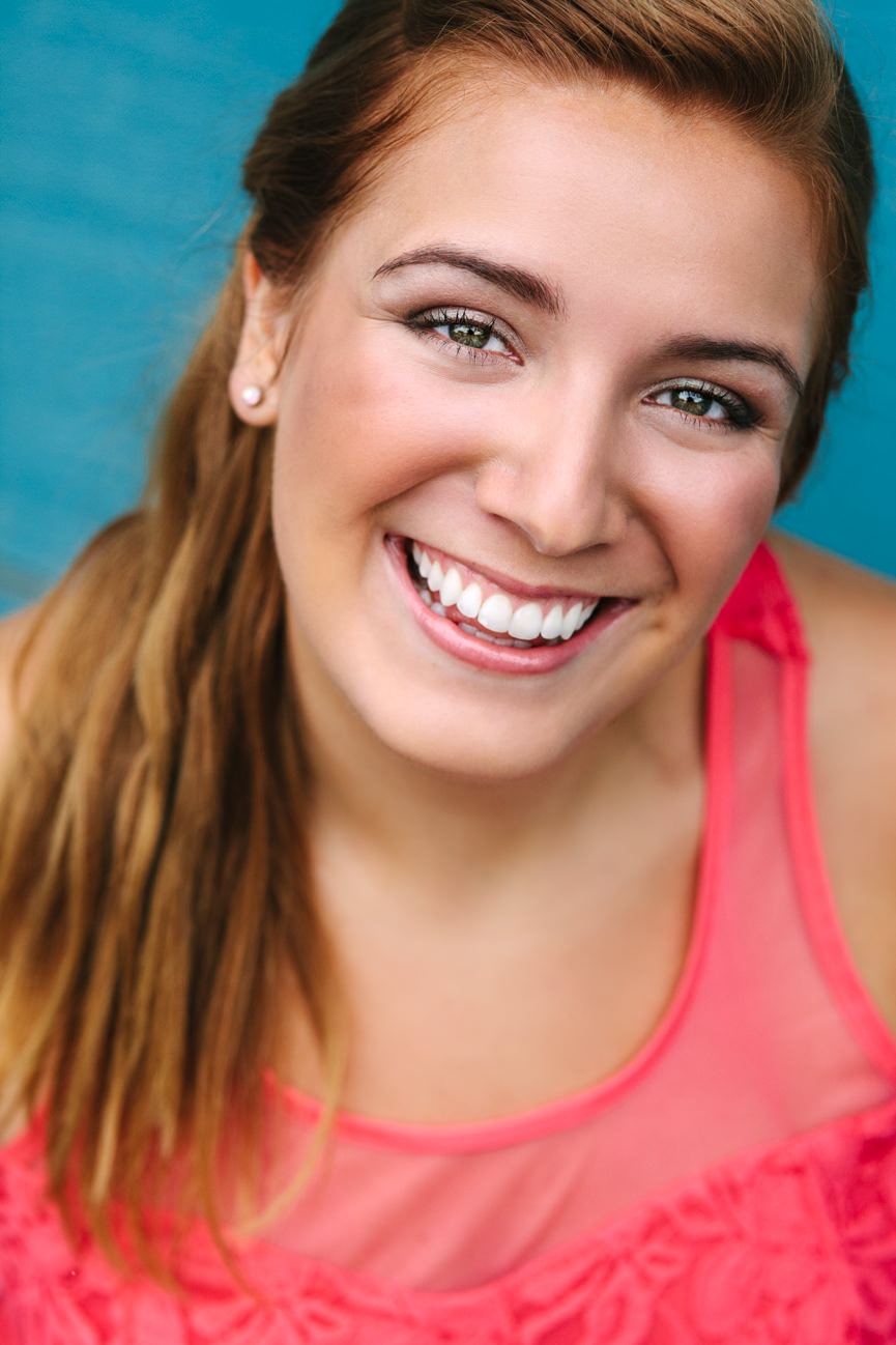 A woman wearing pink smiles for her headshots in Missoula Montana