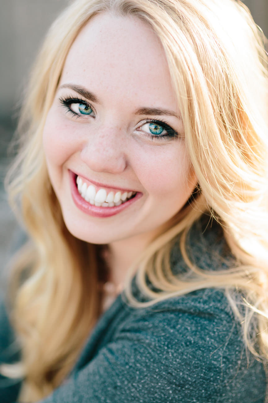 A woman wearing gray smiles for her headshots in Missoula Montana