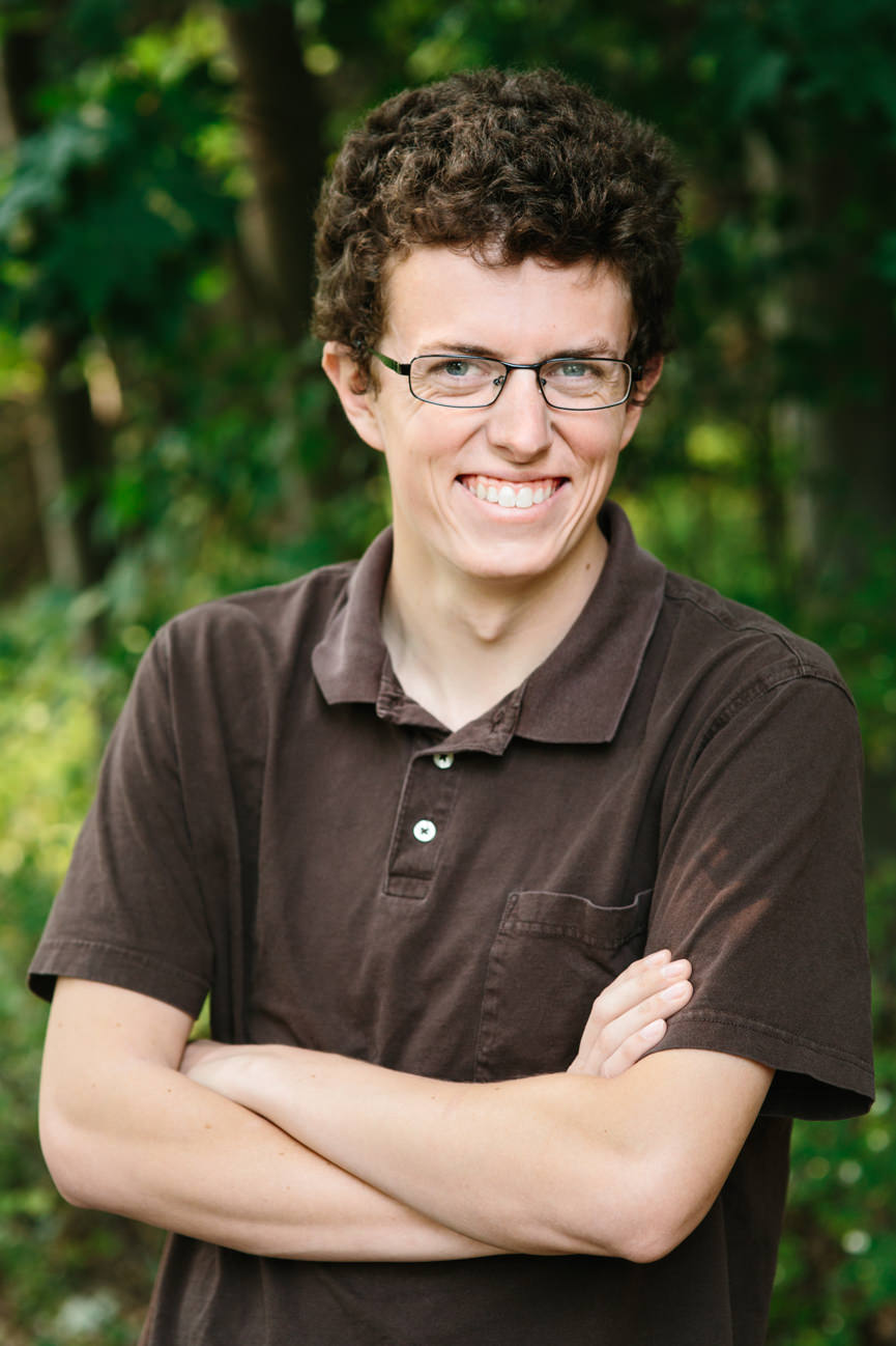 A man wearing brown smiles for his headshots in Missoula Montana