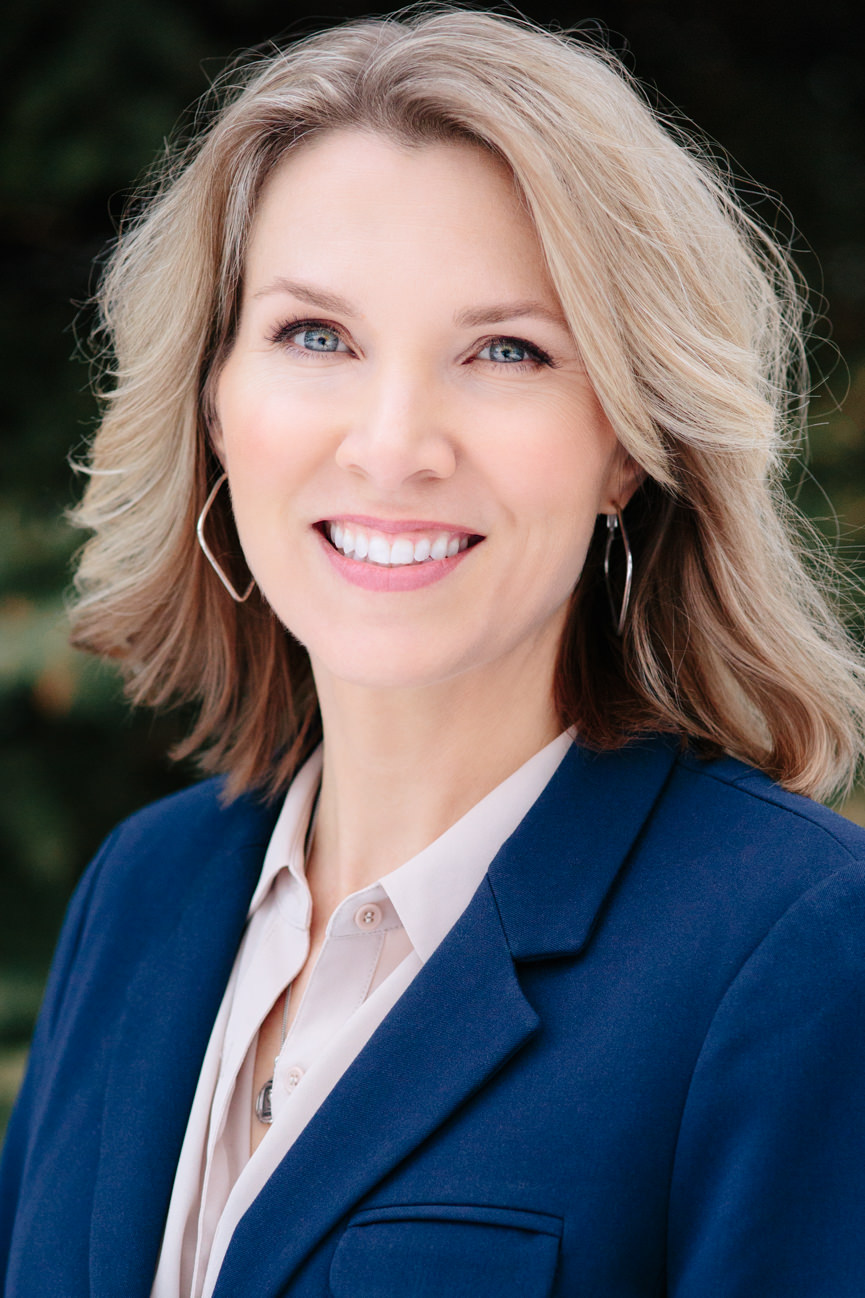 A business woman in a jacket smiles for her headshots in Missoula Montana