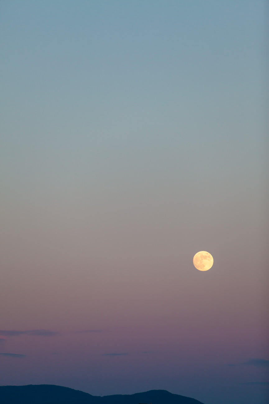 A full moon rises over Ovanda Montana on a summer evening