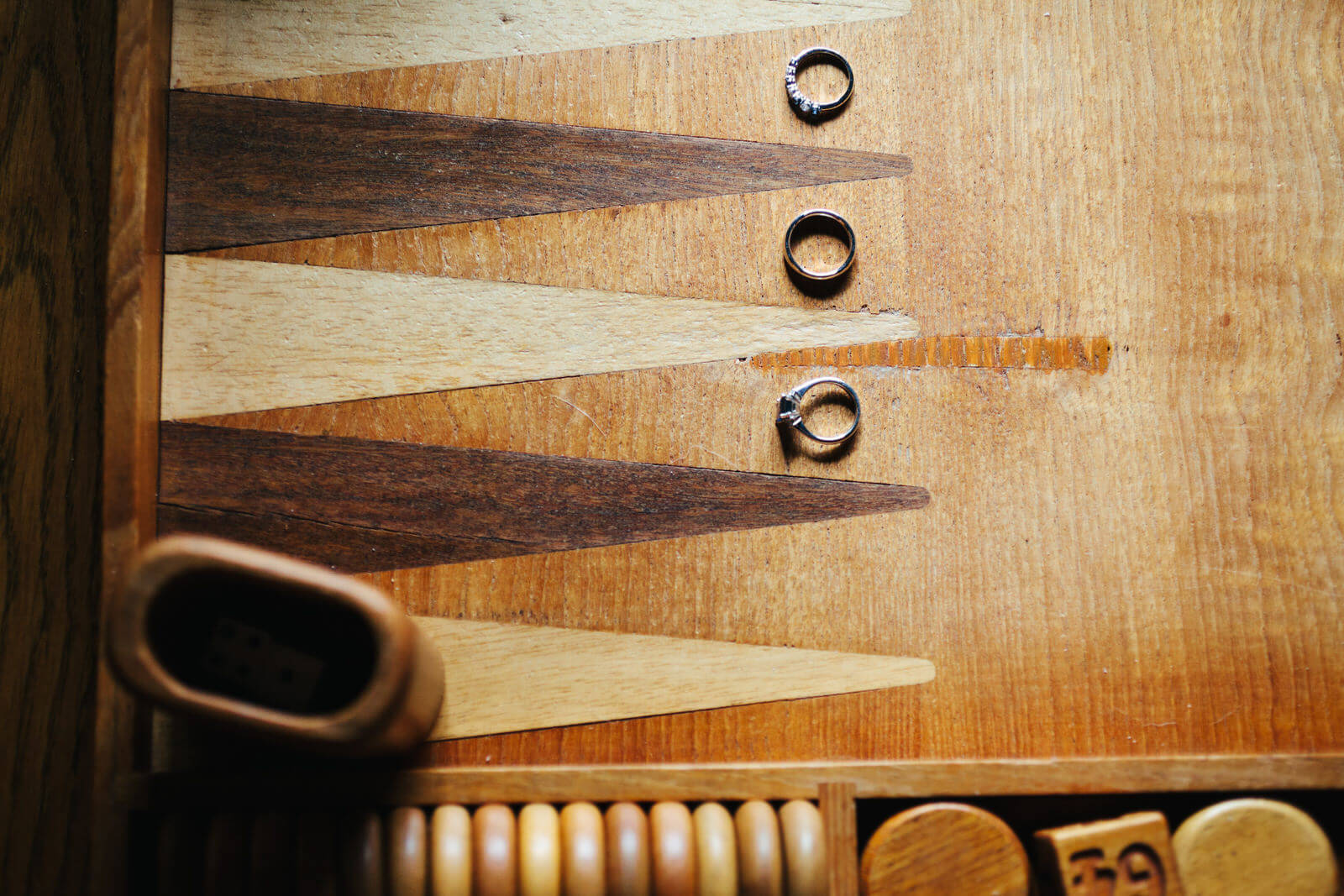 Rings are placed atop a wooden backgammon board at a Philipsburg Montana wedding
