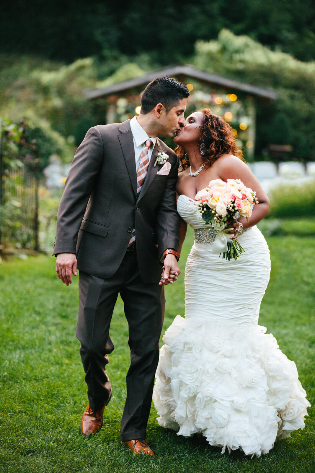 A bride and groom kiss during their wedding day at the Camrose Hill Flower Farm in Stillwater Minnesota