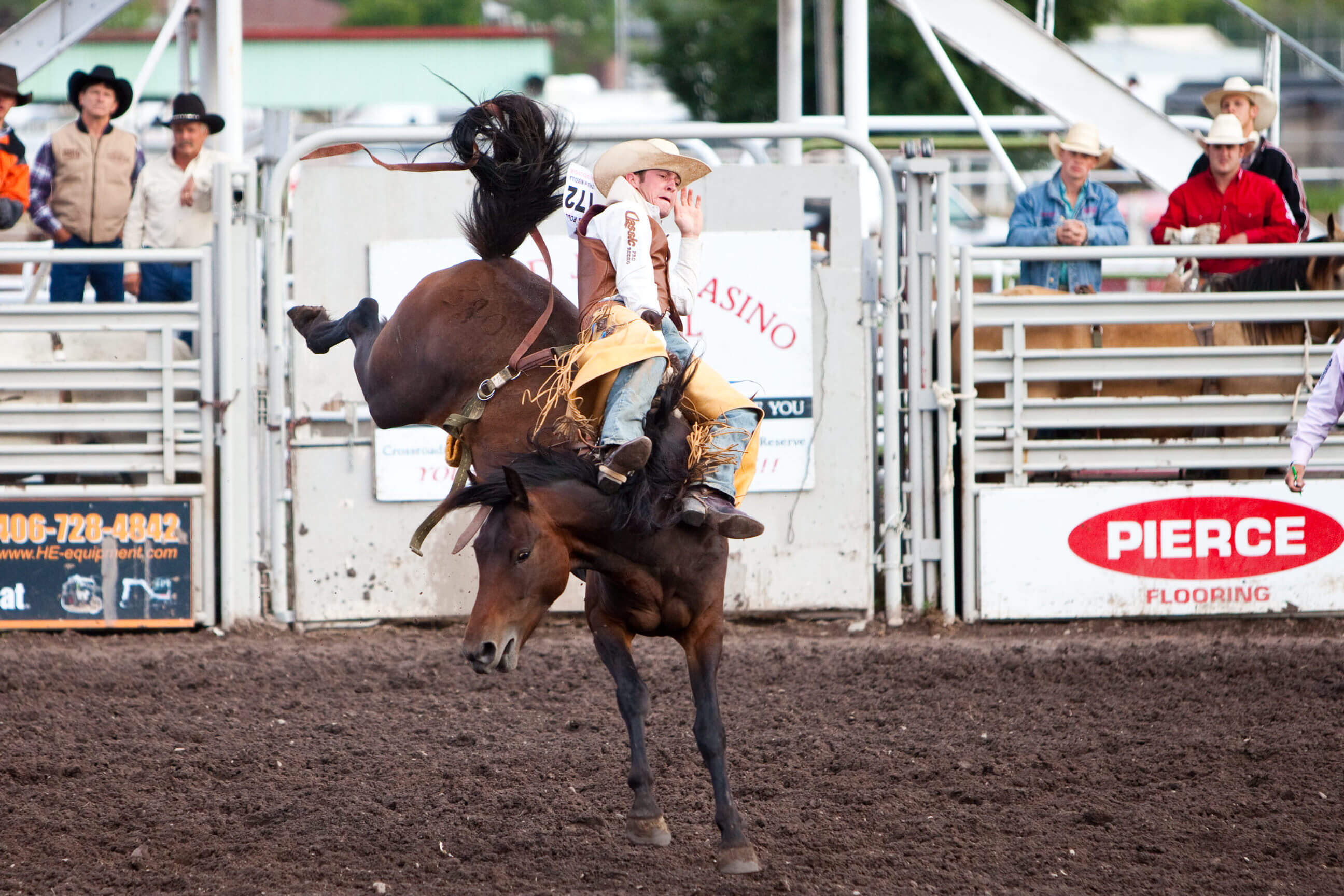 A cowboy competes on a bucking bronco during a rodeo at the Western Montana State Fair in Missoula Montana