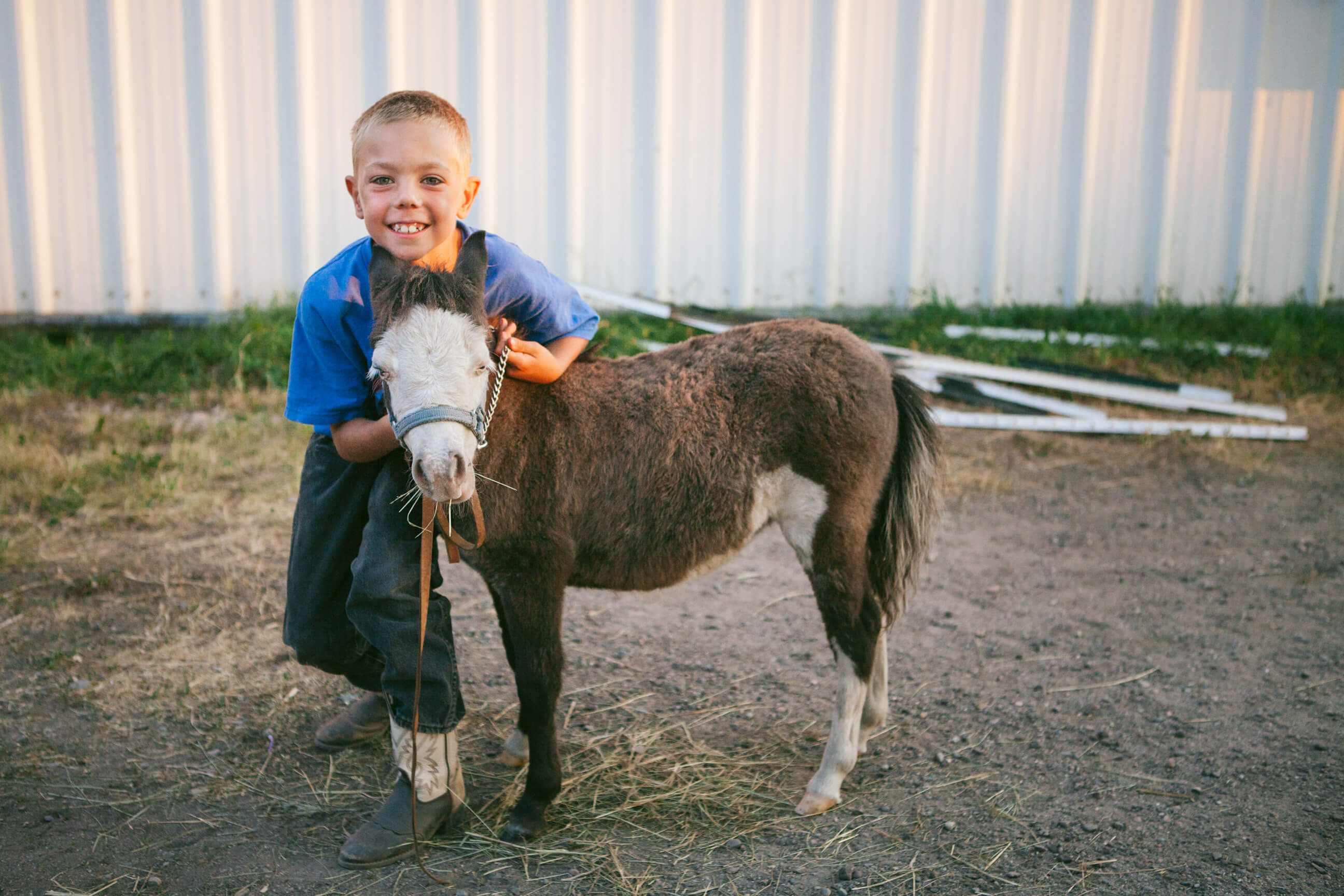 A young boy smiles and holds his pony at the Western Montana State Fair in Missoula Montana