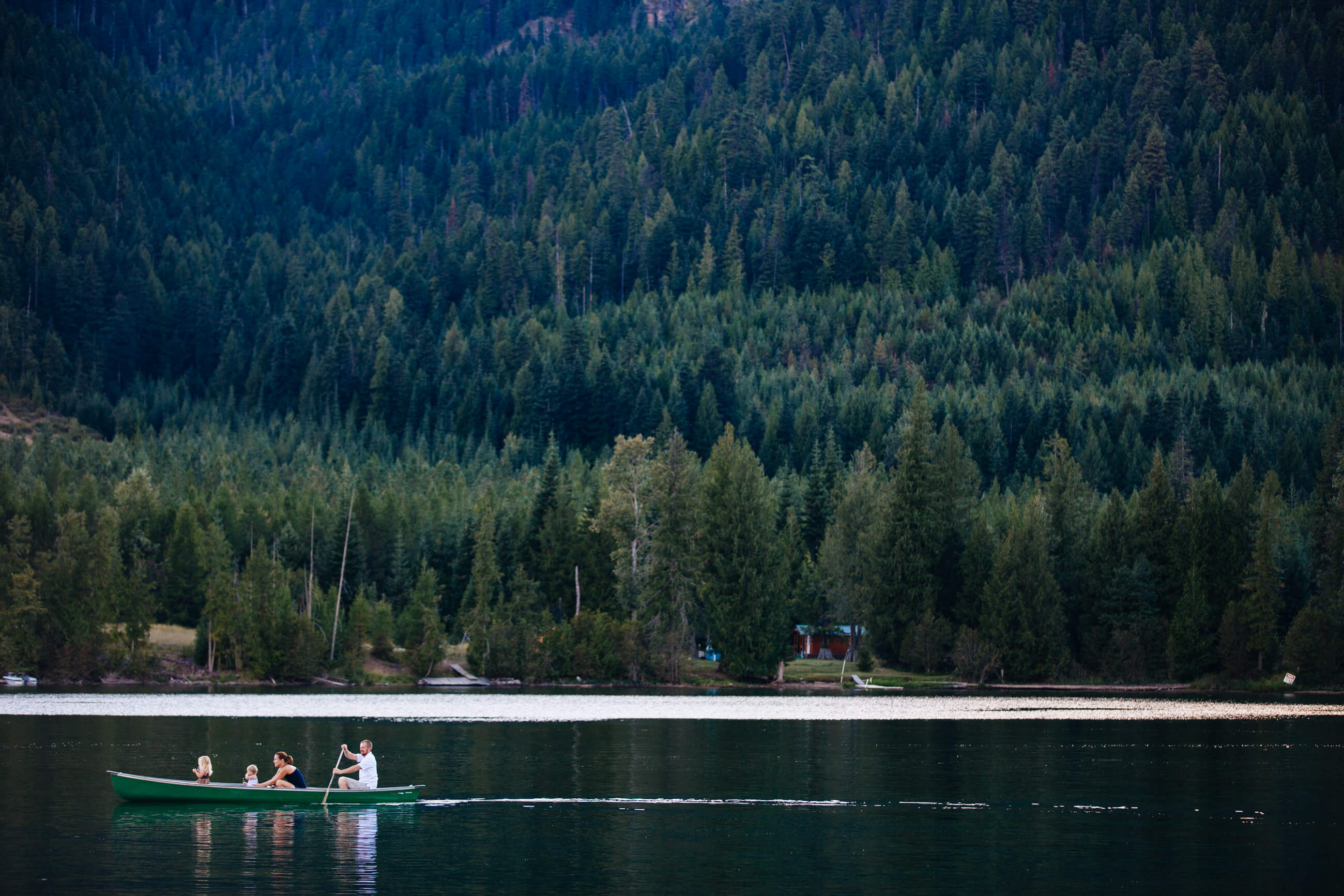 A family of four canoes on Bull Lake in Montana