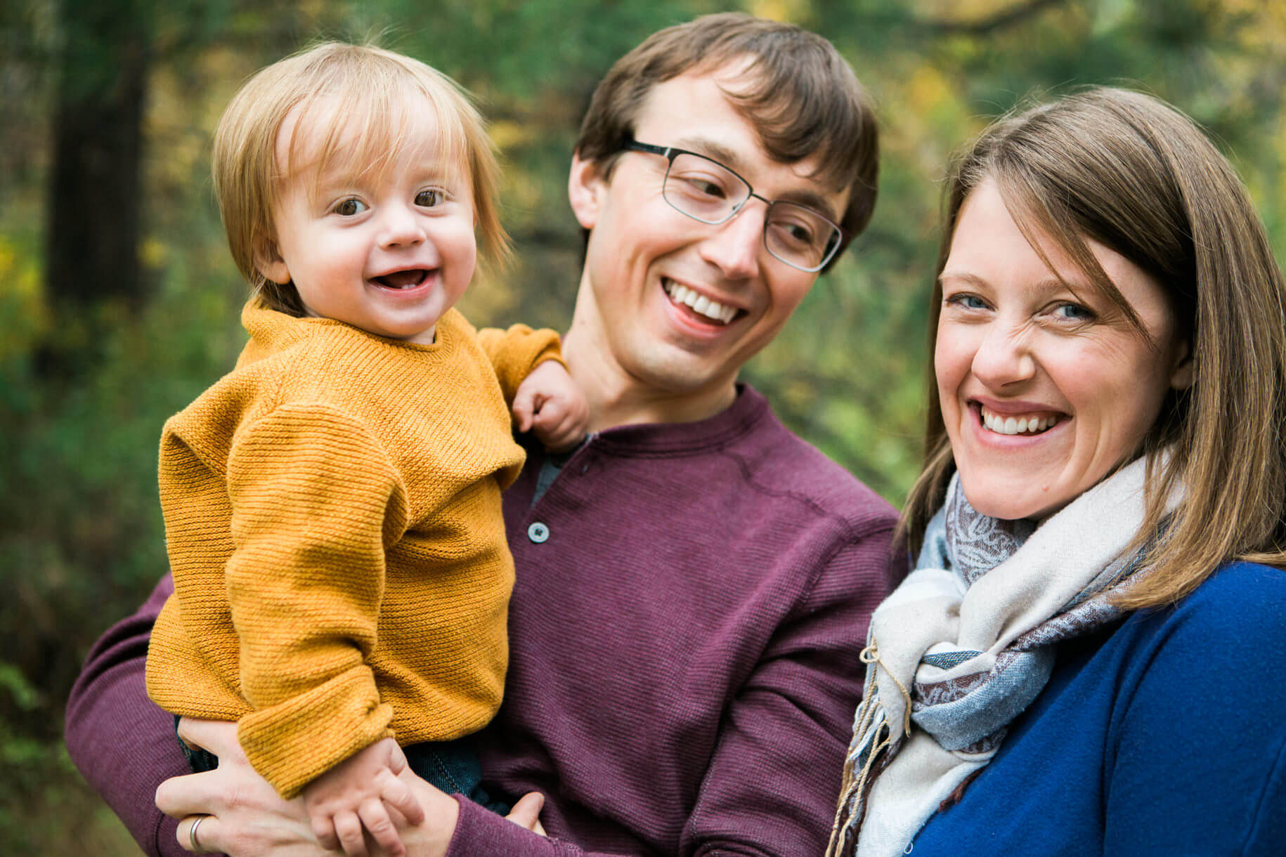 A couple and their toddler laugh and smile together in Missoula Montana