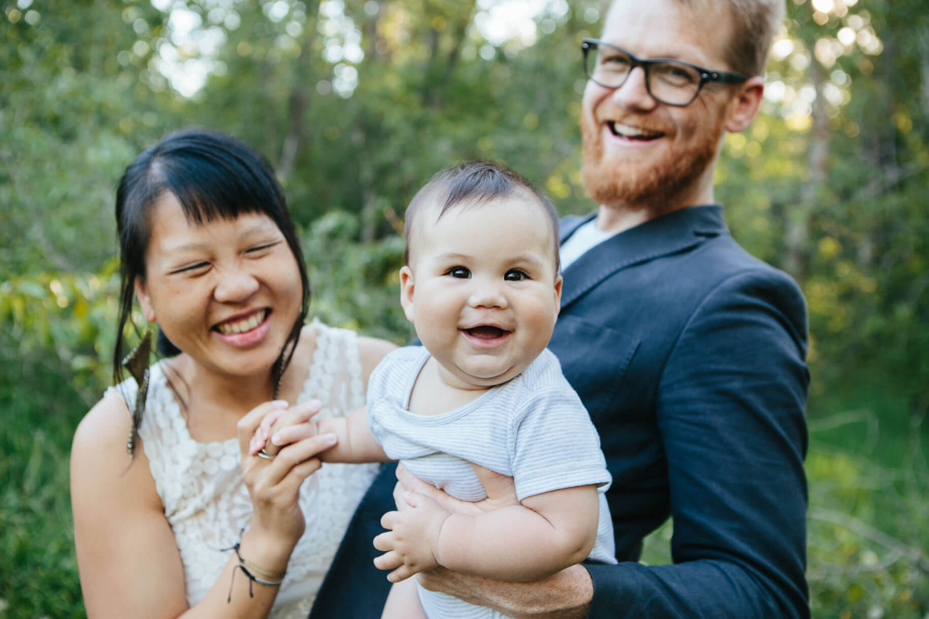 A mother and father smile as they hold their baby girl during their family session in Missoula Montana