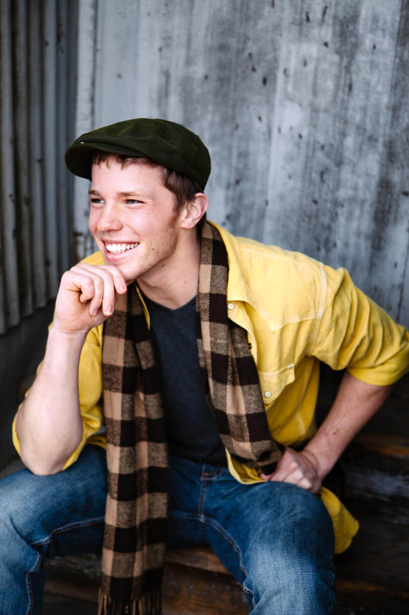 A man sits and laughs during his portrait session in Missoula Montana