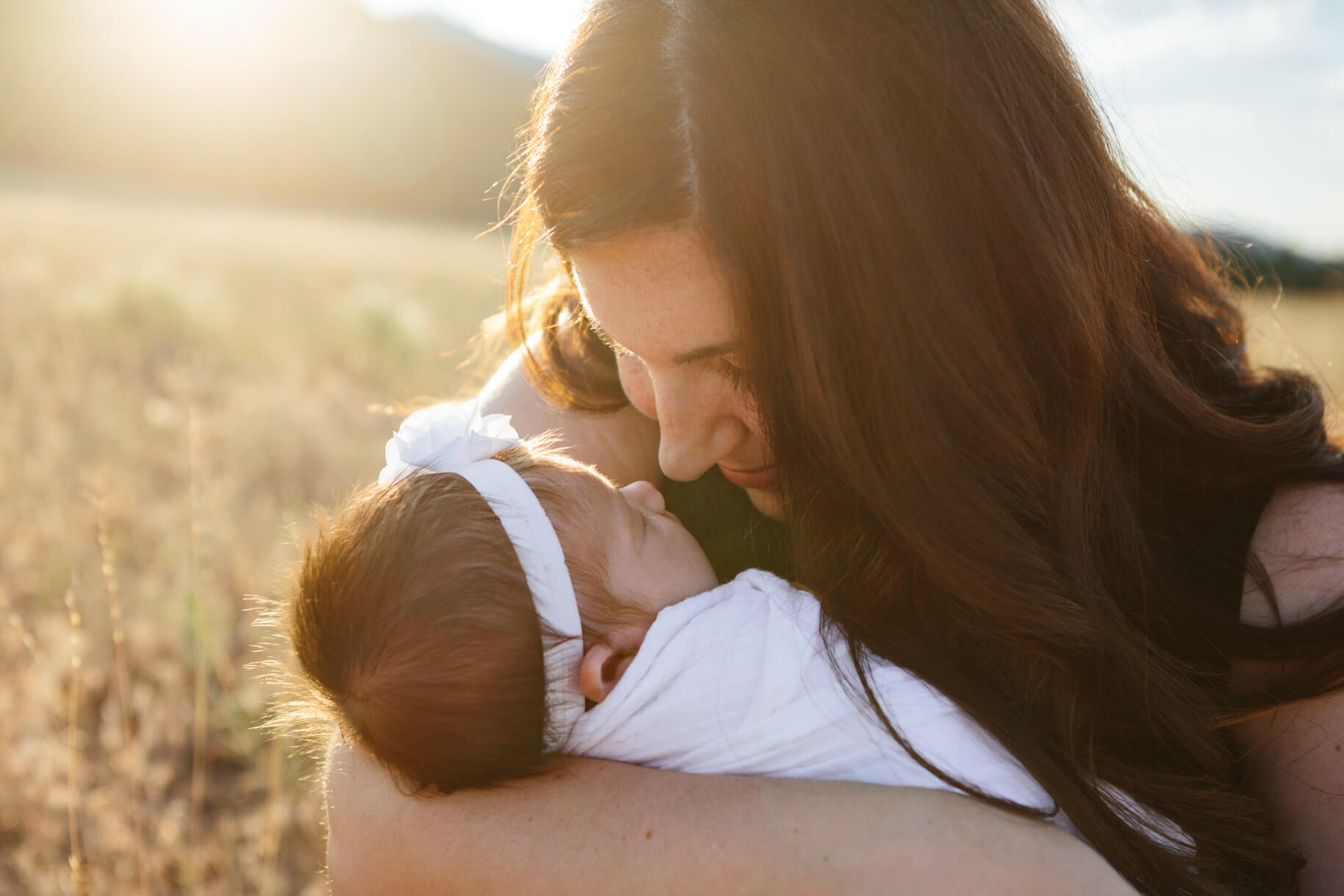 A mother looks at her newborn baby girl during their newborn photos in Missoula Montana