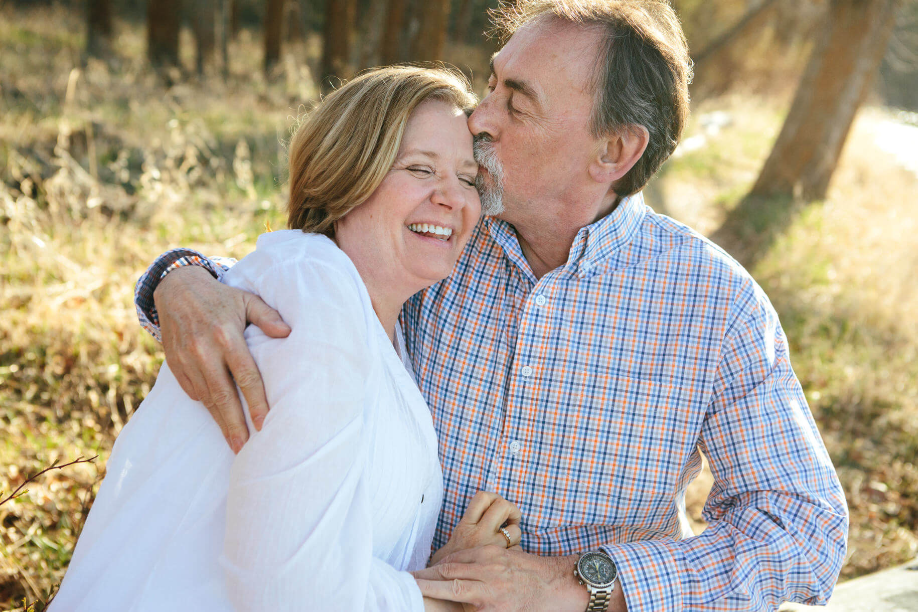 A man kisses his wife during their couples portraits in Missoula Montana