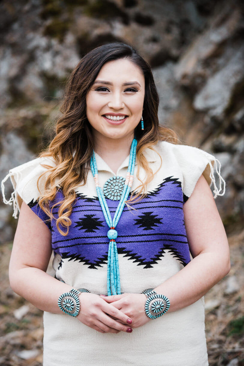 A Navajo woman wears a traditional dress for her college graduation portraits in Missoula Montana