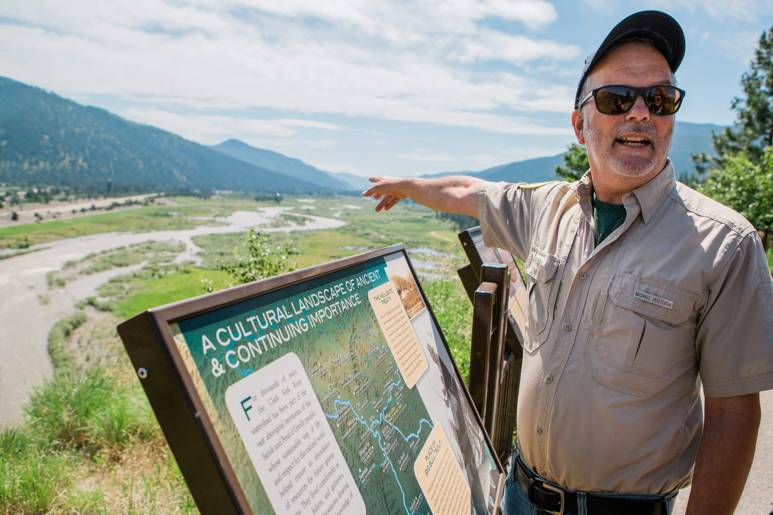 A man points at a flood plain at Milltown State Park in Montana