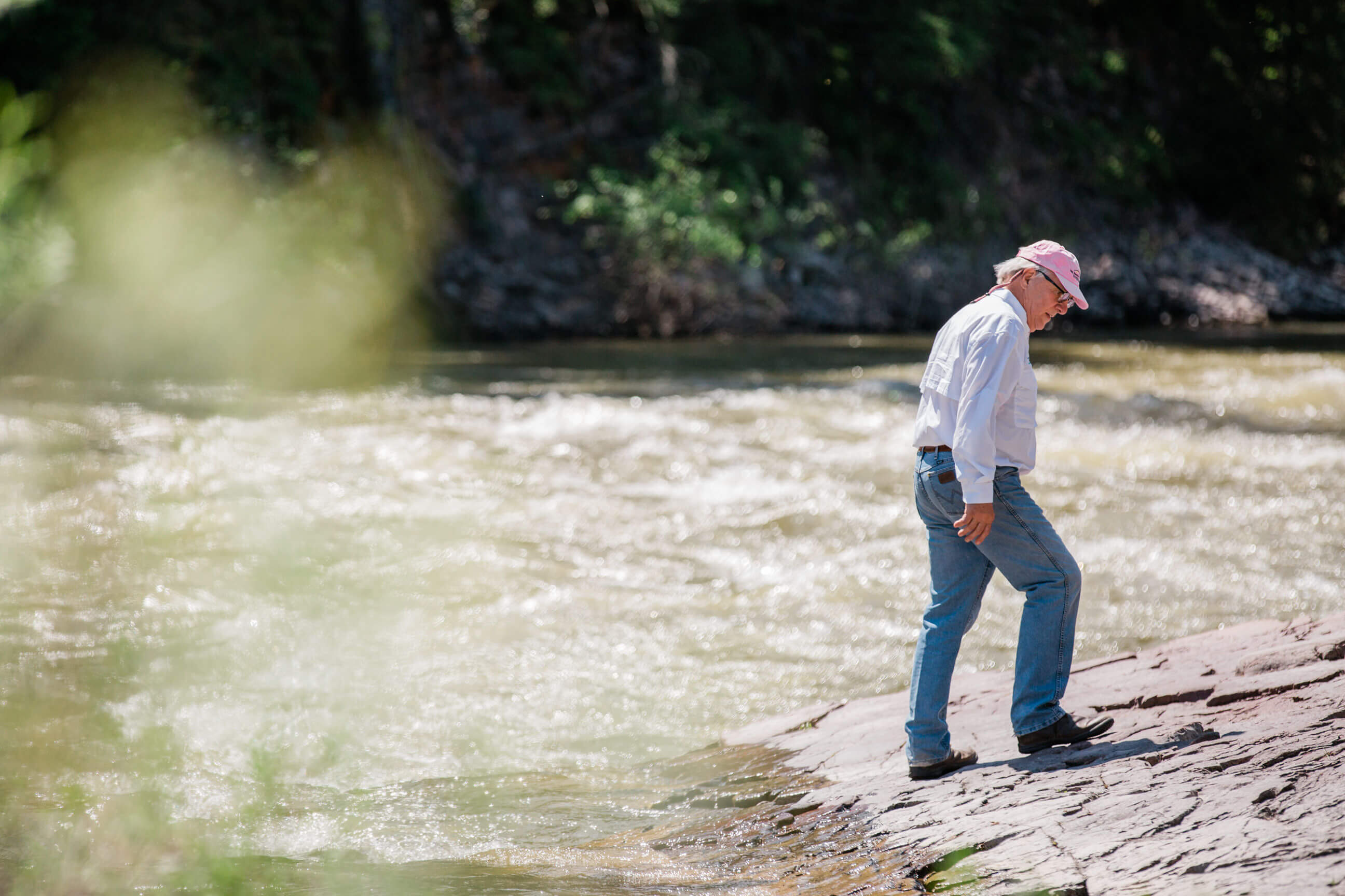 A man stands on a rock on the Blackfoot River in Montana