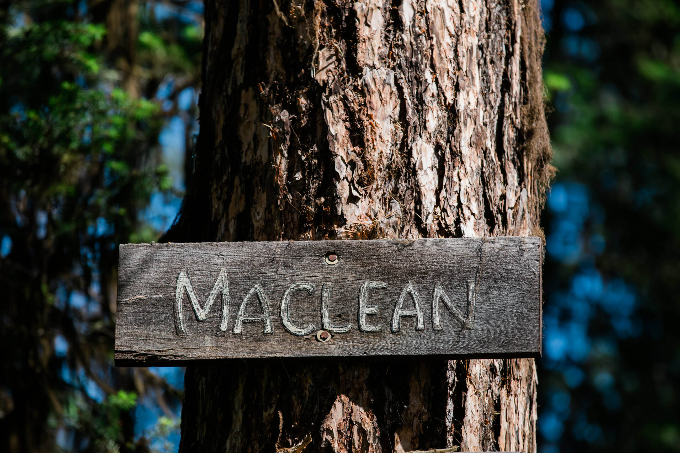 A sign indicates Norman Maclean's cabin on Seeley Lake is nearby