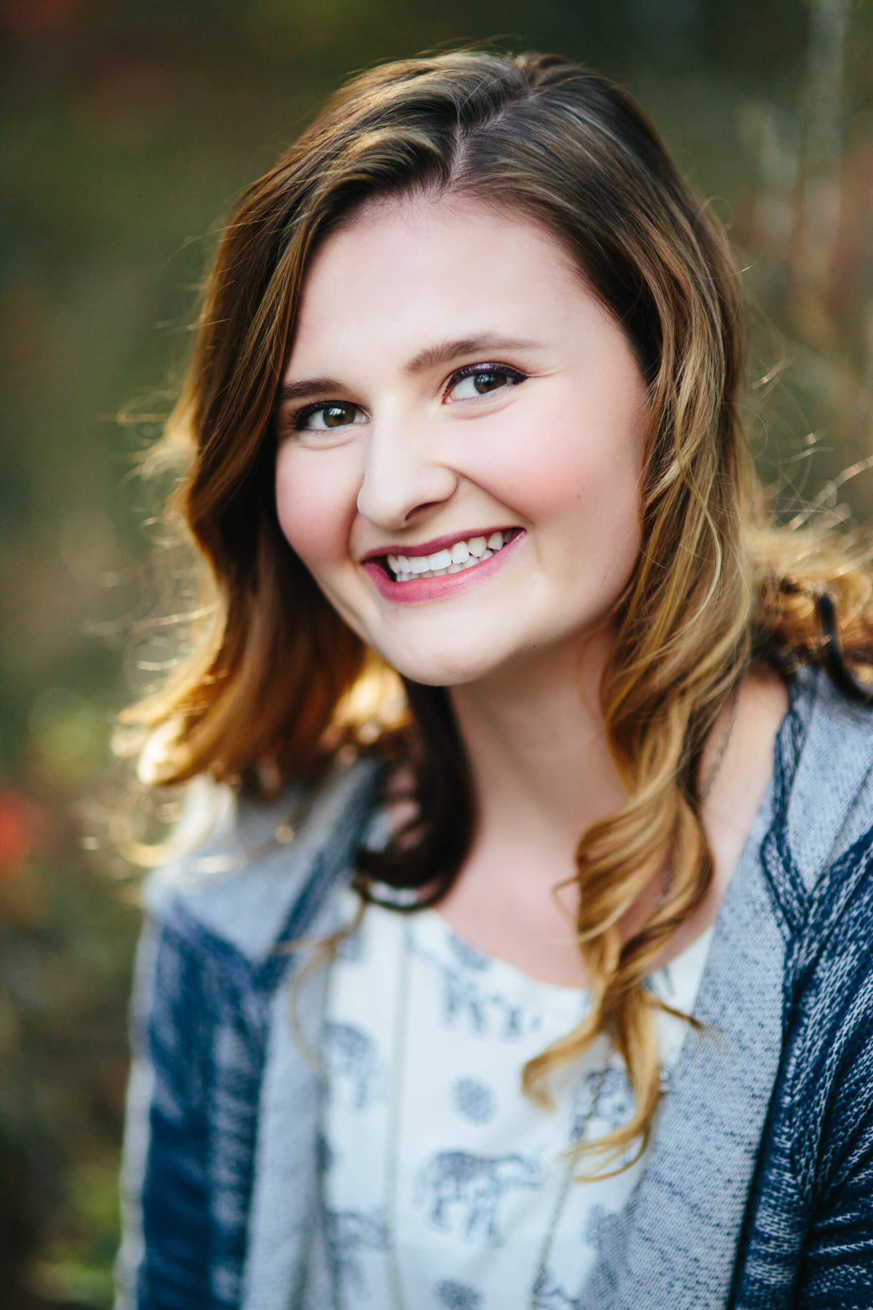 A senior girl laughs and smiles during her Missoula Montana senior photos