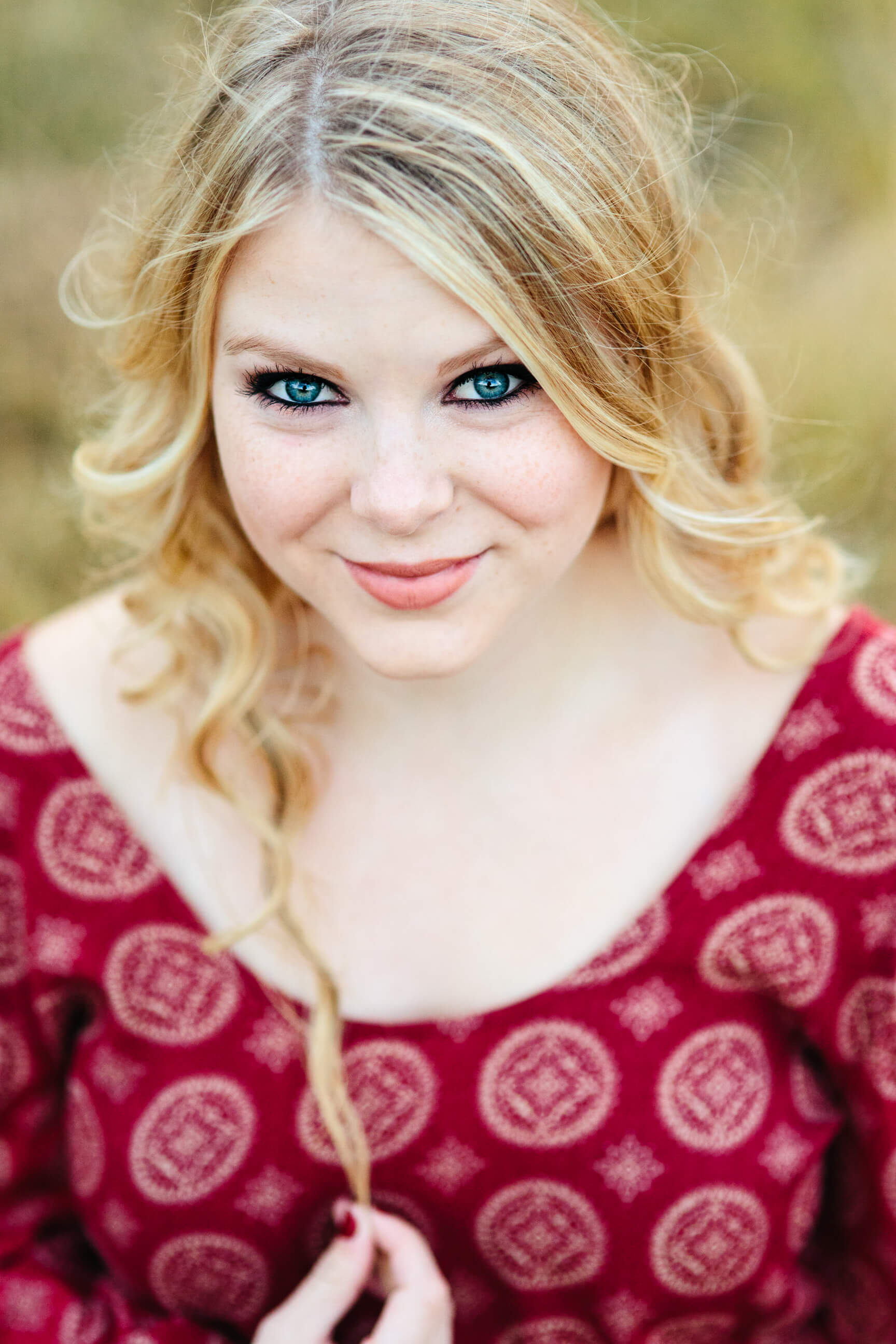 A senior girl smiles during her Missoula senior portraits