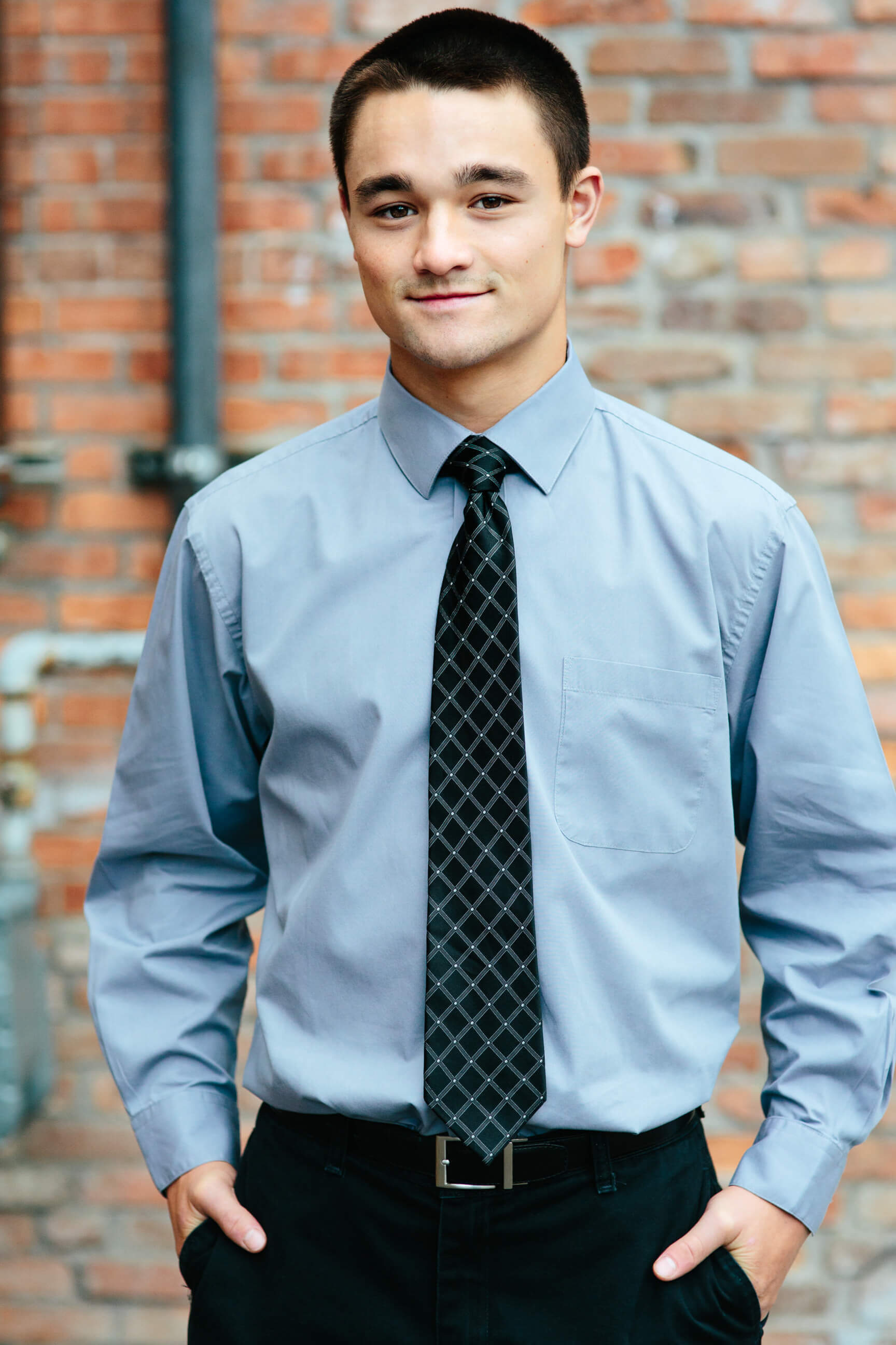 A senior boy looks at the camera during his senior portraits in Missoula Montana