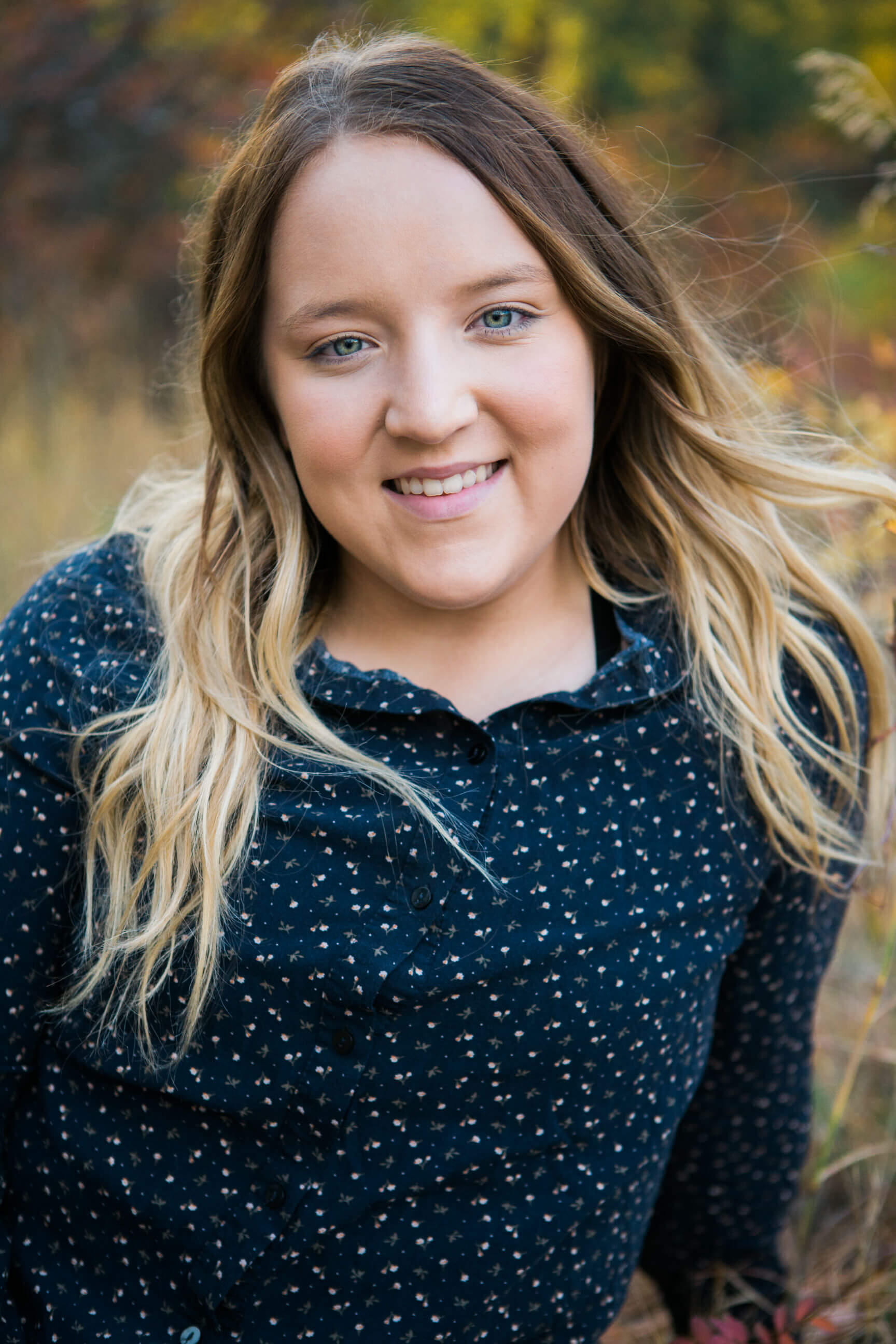 A senior girl smiles at the camera during her Missoula senior portrait session