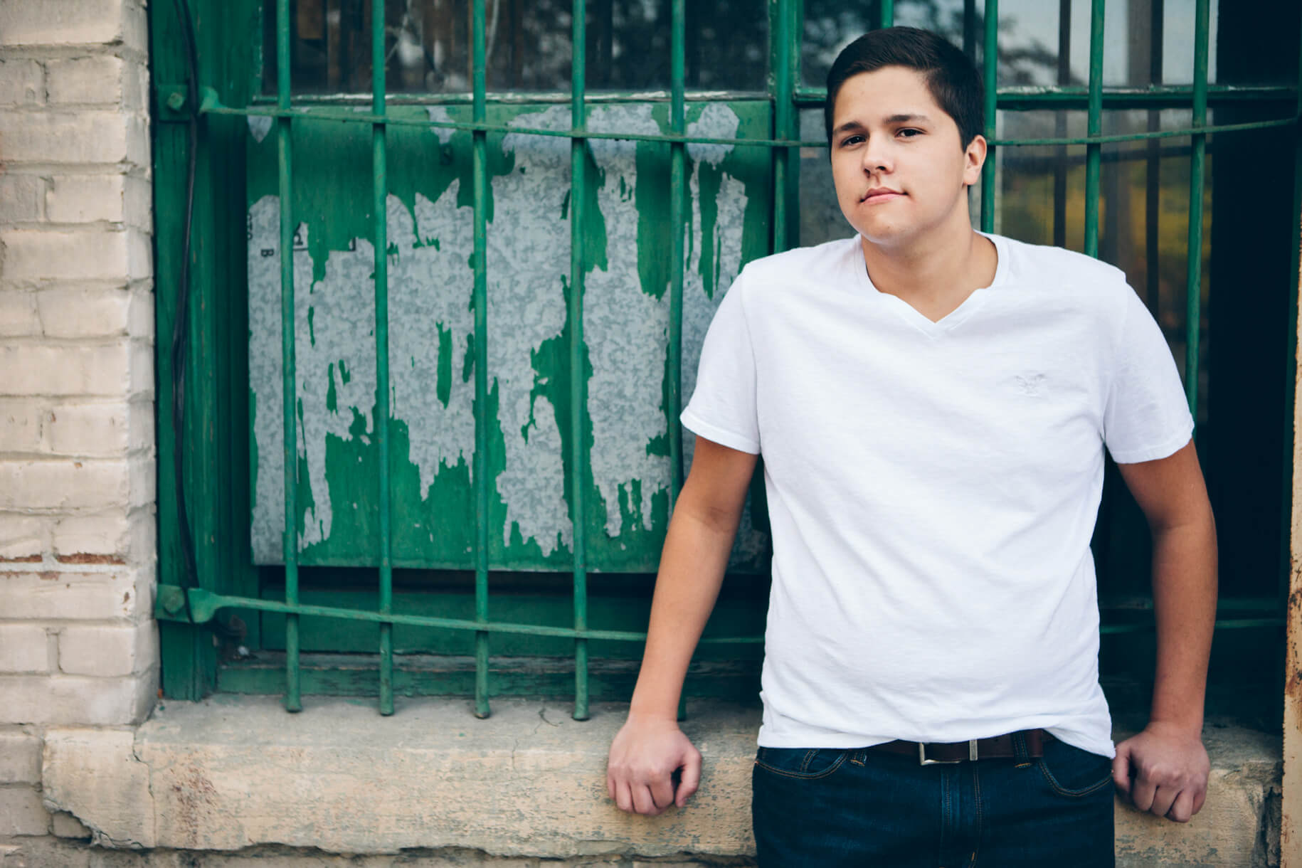 A high school senior boy looks at the camera during his senior photos in Missoula Montana