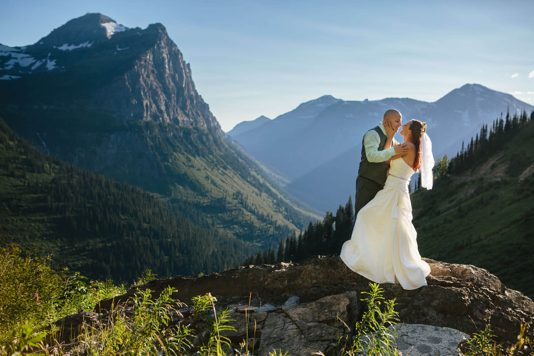 A groom kisses his bride at their Glacier National Park elopement in Montana