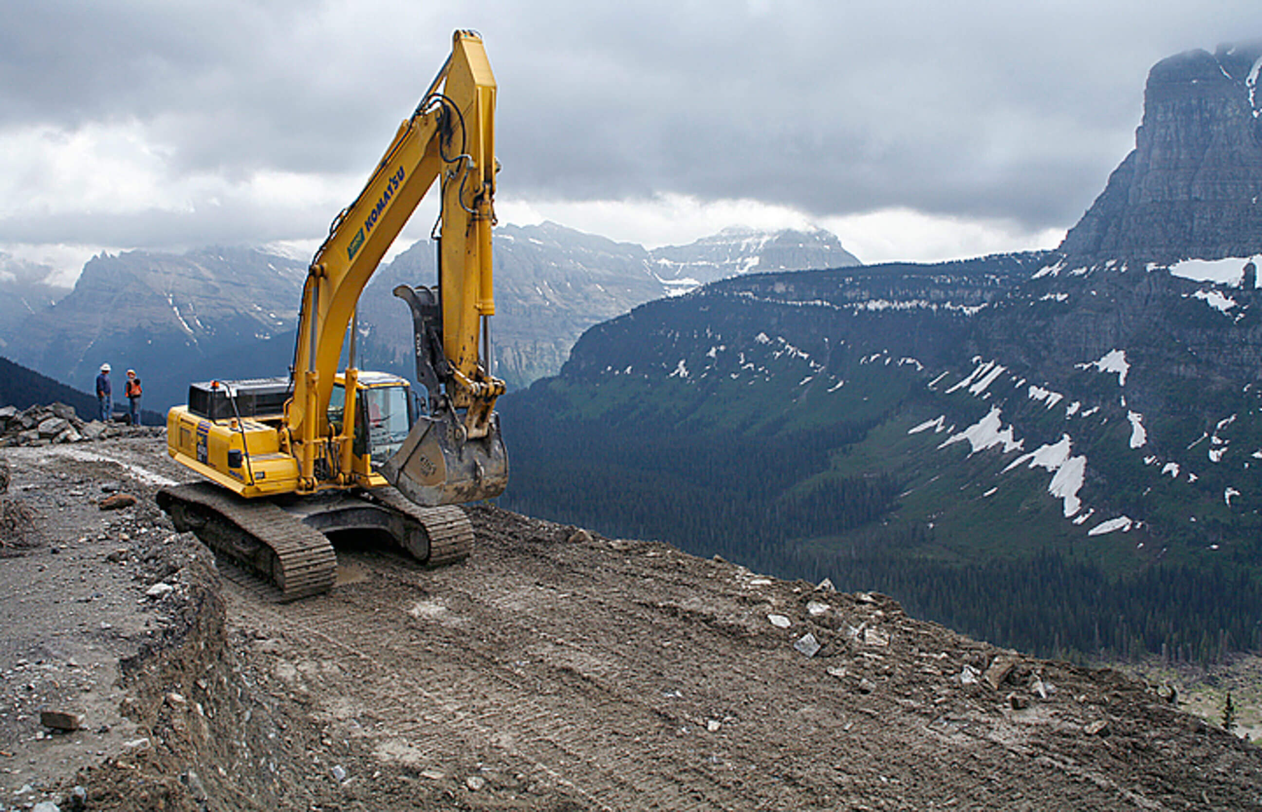 Construction workers discuss the repair of Glacier National Park's Going to the Sun Road in early June