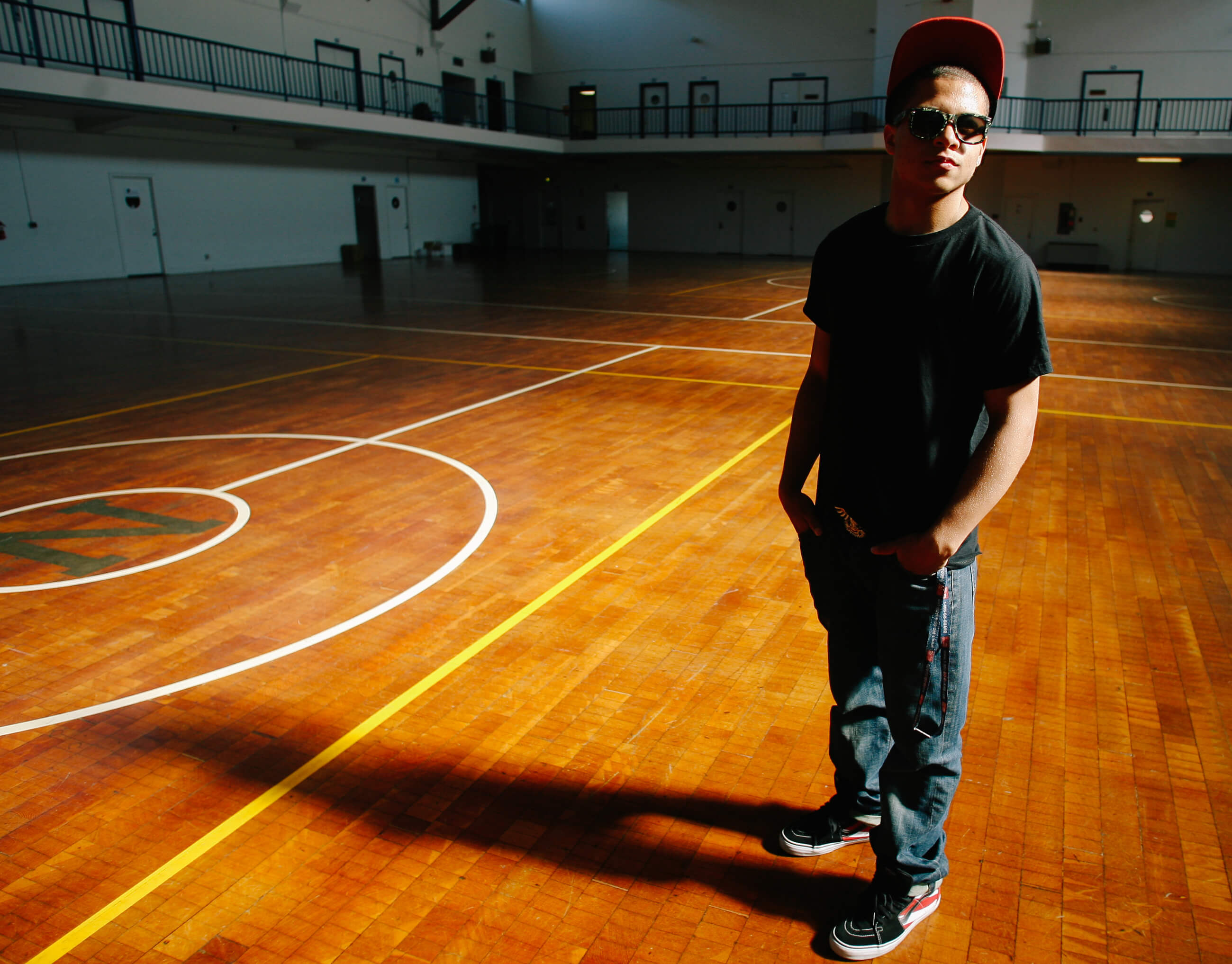 A student poses in a gym for a portrait in Seattle Washington