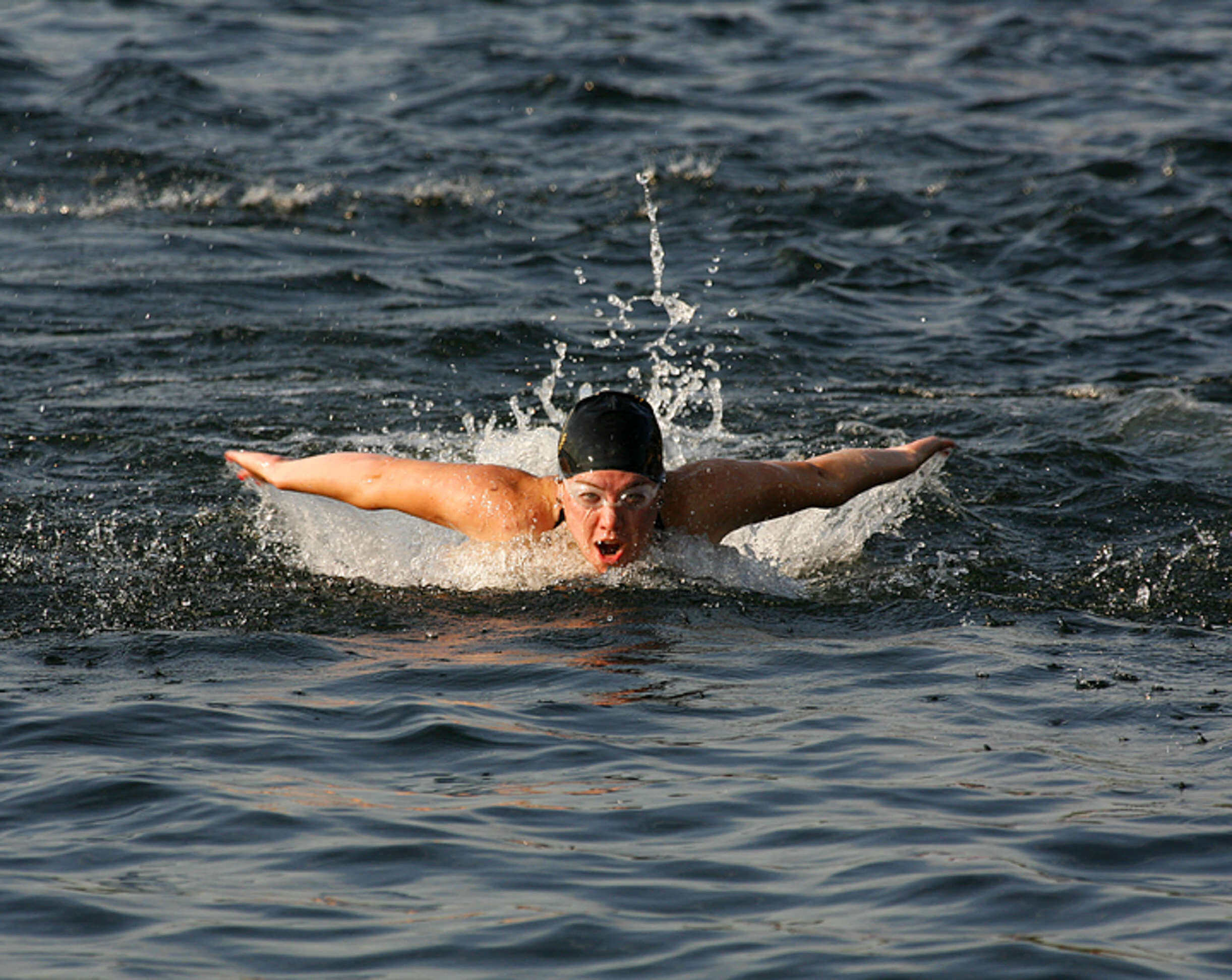 A swimmer competes in lifeguard races at Green Lake in Seattle Washington