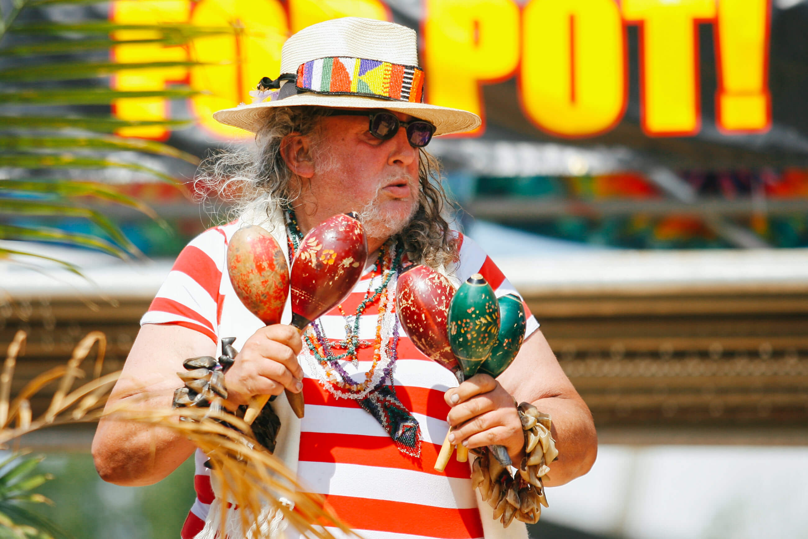 A man with maracas dances during Hempfest in Seattle Washington