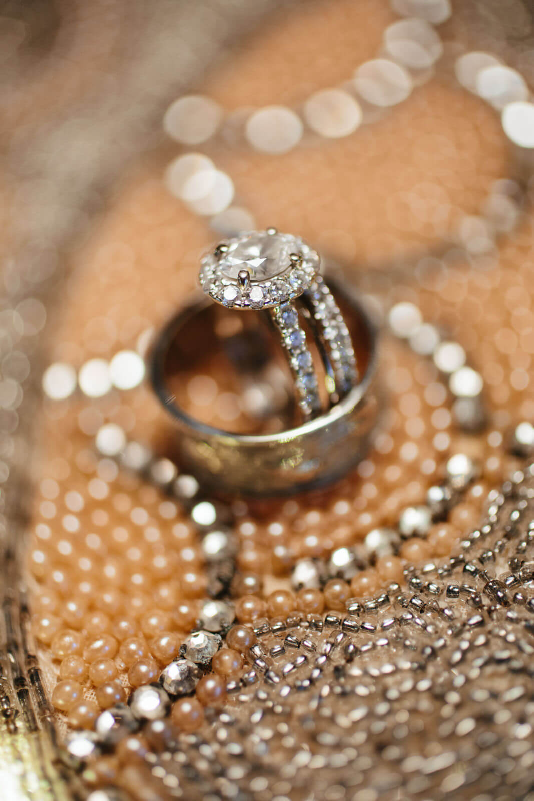 Rings sparkle against a beaded backdrop at a Triple Creek Ranch elopement in Darby Montana