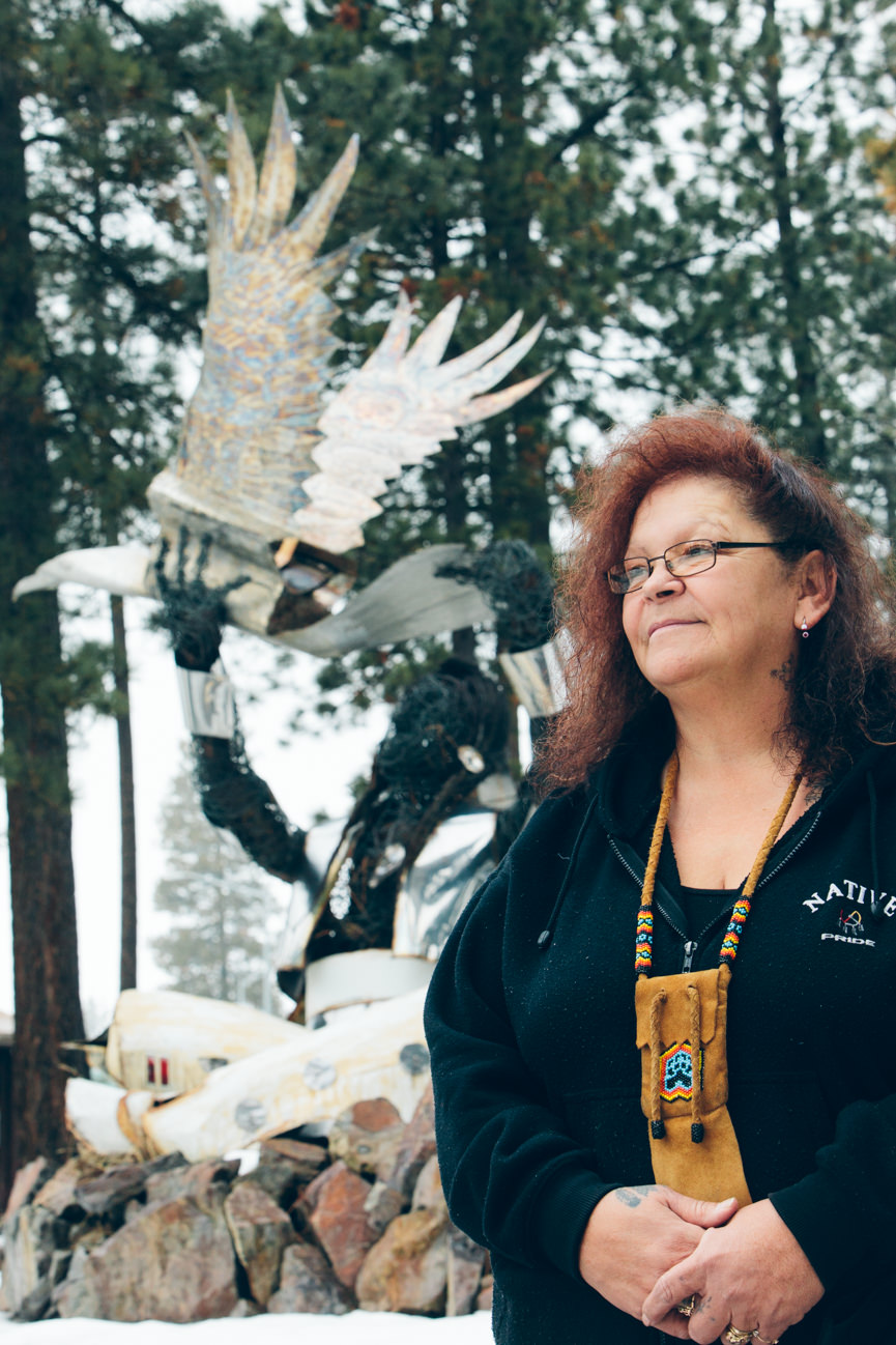 A Native American woman poses near an eagle statue at the Salish Kootenai College in Pablo Montana