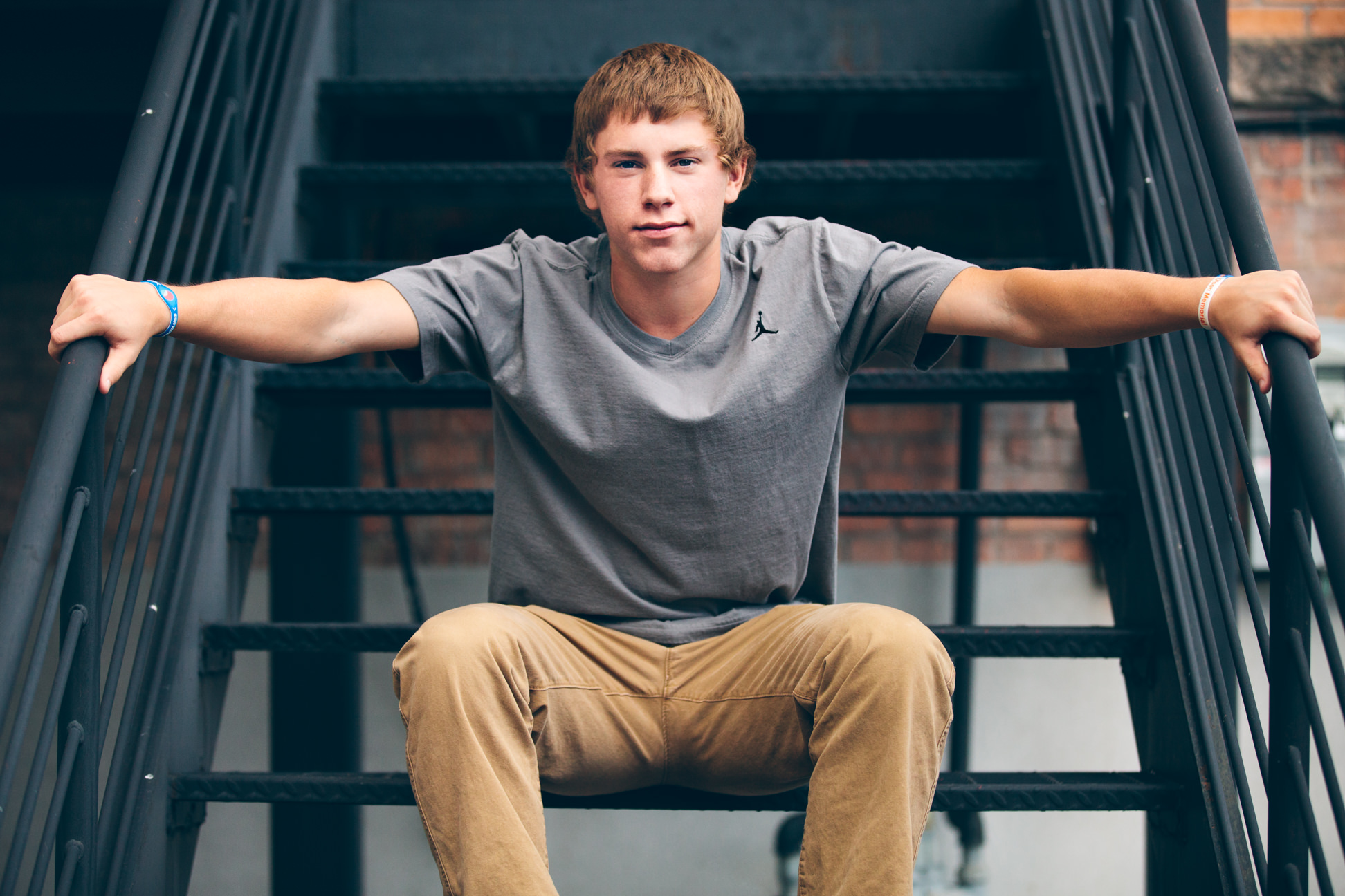 A young man sits on stairs in Missoula Montana