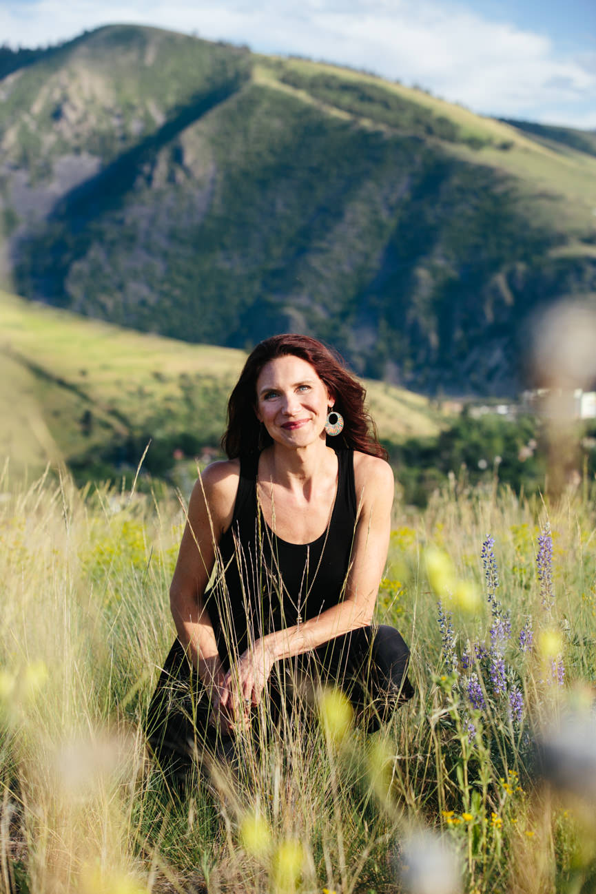 A woman entrepreneur smiles in front of Mount Sentinel in Missoula Montana