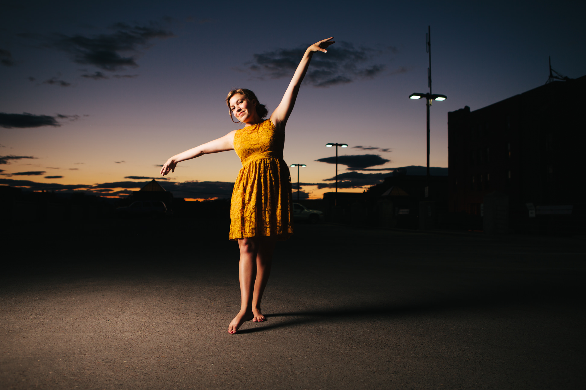 A woman dances during sunset on top of a parking garage in Missoula Montana
