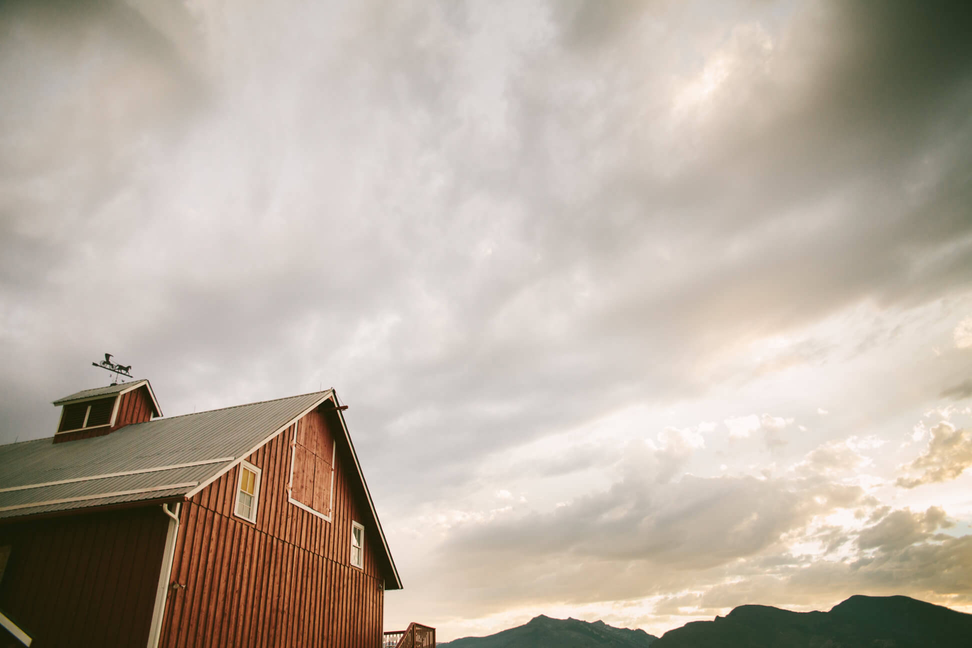 An old barn catches evening light against the Bitterroot Mountain Range in Corvallis Montana